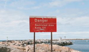 Preview wallpaper danger, sign, shore, stones