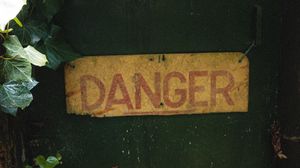 Preview wallpaper danger, words, inscription, plant