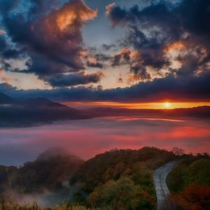 Preview wallpaper dawn, mountains, horizon, clouds, sunlight, road