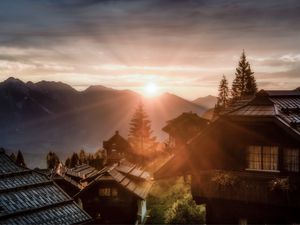 Preview wallpaper dawn, rays, village, buildings