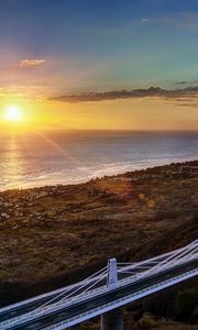 Preview wallpaper decline, coast, bridge, sky, ocean, horizon