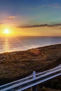 Preview wallpaper decline, coast, bridge, sky, ocean, horizon