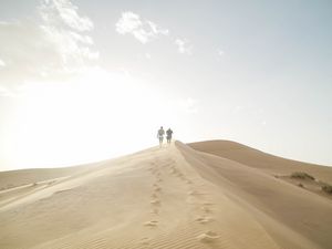 Preview wallpaper desert, people, sand, hills, walk