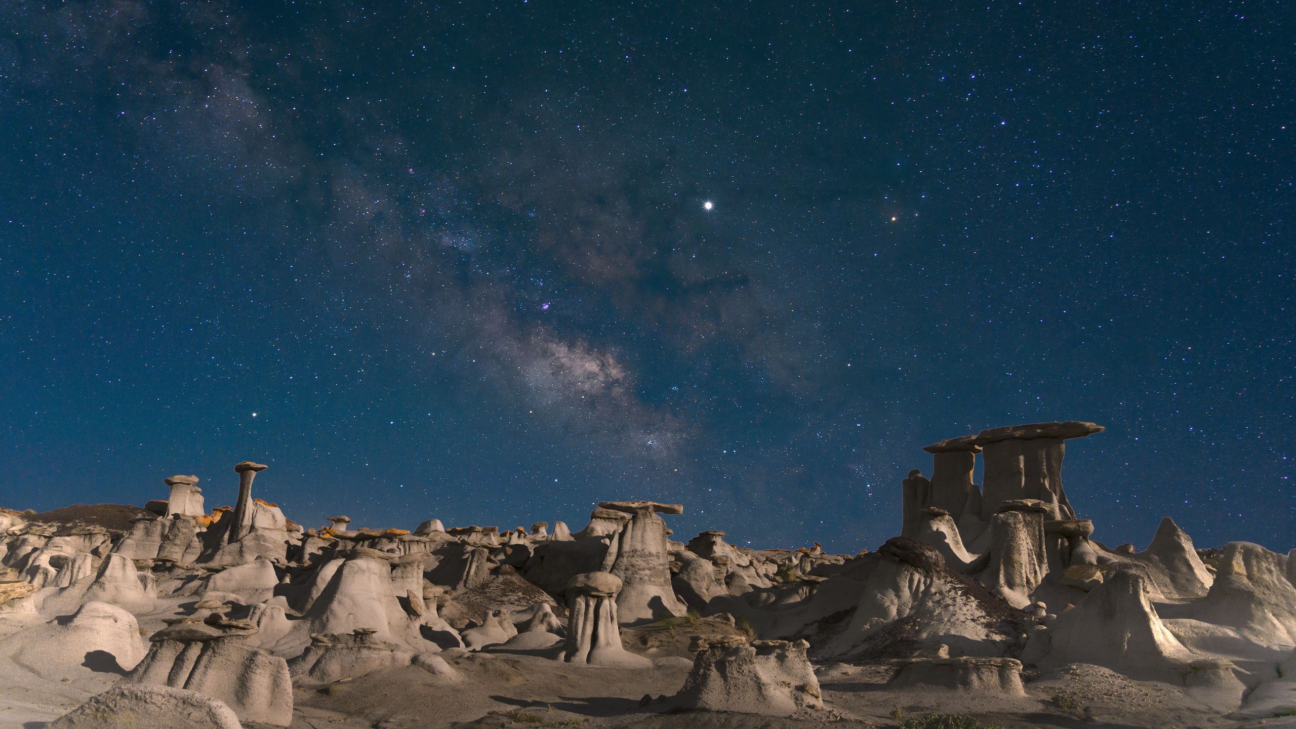 Download wallpaper 2560x1440 desert, rocks, landscape, starry sky