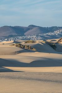 Preview wallpaper desert, sand, hills, city, landscape