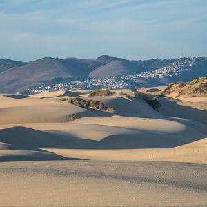 Preview wallpaper desert, sand, hills, city, landscape