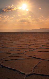 Preview wallpaper desert, sun, rays, mountains, horizon