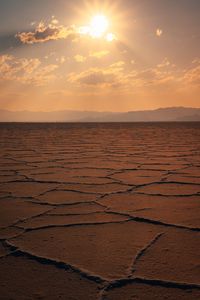 Preview wallpaper desert, sun, rays, mountains, horizon