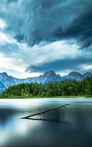 Preview wallpaper driftwood, lake, mountains, sky, clouds