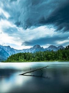 Preview wallpaper driftwood, lake, mountains, sky, clouds