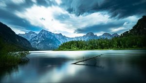 Preview wallpaper driftwood, lake, mountains, sky, clouds