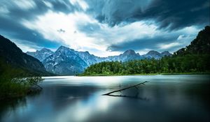 Preview wallpaper driftwood, lake, mountains, sky, clouds