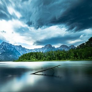 Preview wallpaper driftwood, lake, mountains, sky, clouds