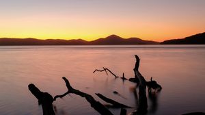 Preview wallpaper driftwood, sea, sunset, horizon, sky