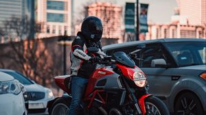 Preview wallpaper ducati, motorcycle, red, motorcyclist, road, cars