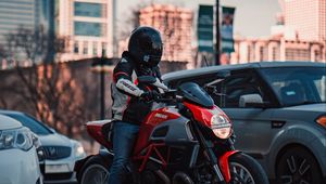 Preview wallpaper ducati, motorcycle, red, motorcyclist, road, cars