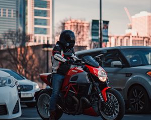 Preview wallpaper ducati, motorcycle, red, motorcyclist, road, cars