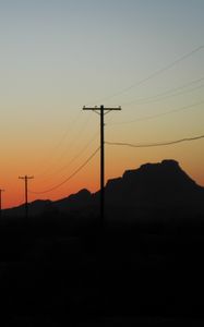 Preview wallpaper electric poles, mountains, silhouettes, nature, dark