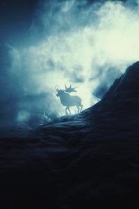 Preview wallpaper elk, mountains, smoke, light, silhouette, horns, stones
