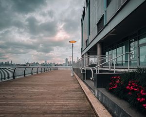 Preview wallpaper embankment, lantern, city, pier, wooden