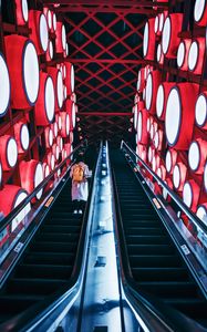 Preview wallpaper escalator, interior, lights, man, steps, red