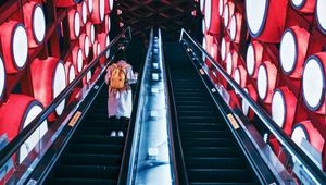 Preview wallpaper escalator, interior, lights, man, steps, red