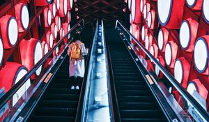 Preview wallpaper escalator, interior, lights, man, steps, red