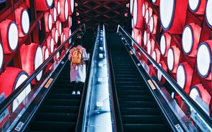 Preview wallpaper escalator, interior, lights, man, steps, red