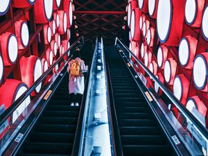 Preview wallpaper escalator, interior, lights, man, steps, red