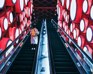 Preview wallpaper escalator, interior, lights, man, steps, red