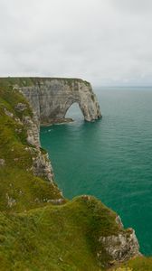 Preview wallpaper etretat cliffs, rocks, arch, sea, plants, clouds, nature, france