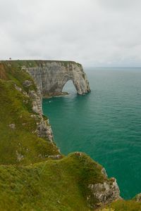 Preview wallpaper etretat cliffs, rocks, arch, sea, plants, clouds, nature, france