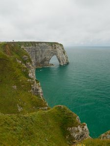 Preview wallpaper etretat cliffs, rocks, arch, sea, plants, clouds, nature, france