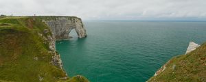 Preview wallpaper etretat cliffs, rocks, arch, sea, plants, clouds, nature, france