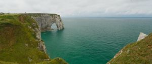 Preview wallpaper etretat cliffs, rocks, arch, sea, plants, clouds, nature, france