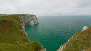 Preview wallpaper etretat cliffs, rocks, arch, sea, plants, clouds, nature, france