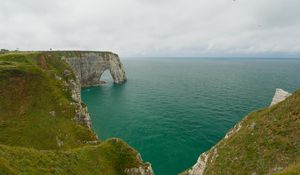 Preview wallpaper etretat cliffs, rocks, arch, sea, plants, clouds, nature, france