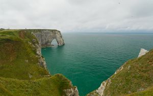 Preview wallpaper etretat cliffs, rocks, arch, sea, plants, clouds, nature, france