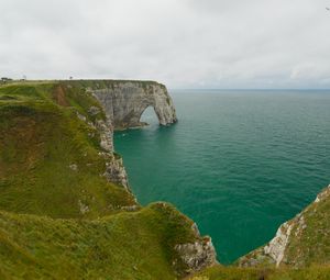 Preview wallpaper etretat cliffs, rocks, arch, sea, plants, clouds, nature, france