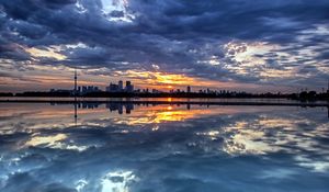 Preview wallpaper evening, decline, city, island, distance, coast, clouds, reflection