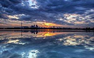 Preview wallpaper evening, decline, city, island, distance, coast, clouds, reflection