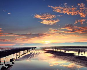 Preview wallpaper evening, outflow, stakes, sand, water