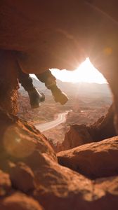 Preview wallpaper feet, cave, rock, mountain, sunset