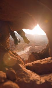 Preview wallpaper feet, cave, rock, mountain, sunset