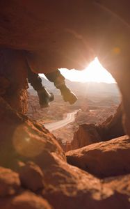 Preview wallpaper feet, cave, rock, mountain, sunset