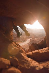 Preview wallpaper feet, cave, rock, mountain, sunset