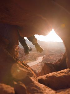 Preview wallpaper feet, cave, rock, mountain, sunset