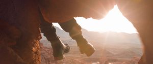 Preview wallpaper feet, cave, rock, mountain, sunset