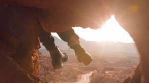 Preview wallpaper feet, cave, rock, mountain, sunset
