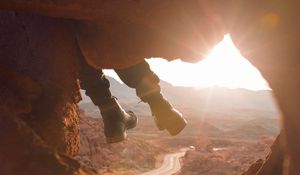 Preview wallpaper feet, cave, rock, mountain, sunset